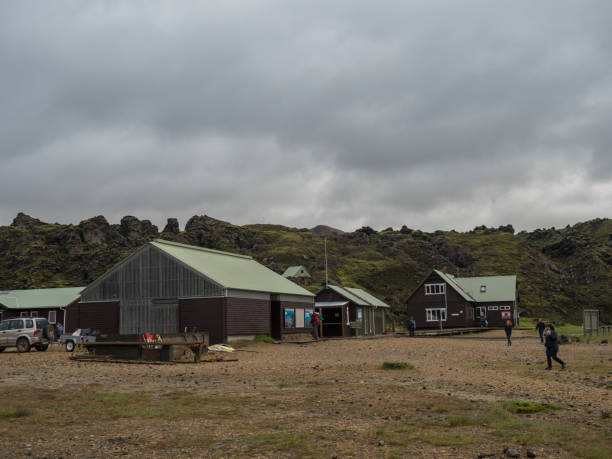 アイスランドの虹の丘のブレニシュタインサルダの景色を望むランドマンナラウガーキャンプ場マウンテンコテージの前にあるハイカーのグループ 有名なラウガヴェグルトレッキングの始ま - camping outdoors iceland red ストックフォトと画像