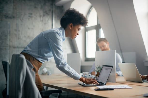 istock Black female entrepreneur typing an e-mail on laptop in the office. 1415806163