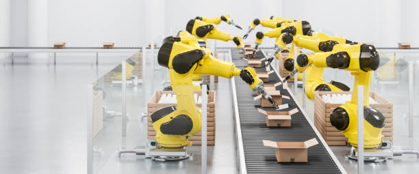 istock Robots at a conveyor belt packing items into cardboard packages. 1415809633
