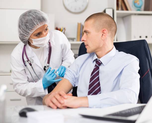 istock Vaccination of an office worker in company office 1415810558