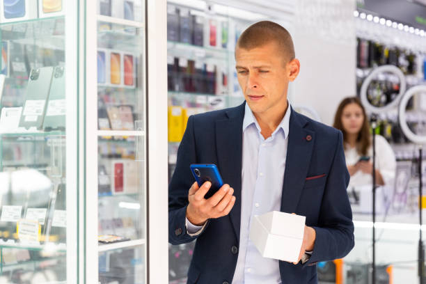 istock Man buyer choosing phone at the multimedia store 1415811193
