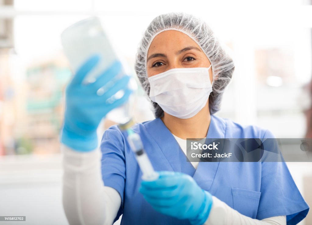 Professional nurse woman making injection in hospital Professional nurse woman making injection in modern hospital 25-29 Years Stock Photo