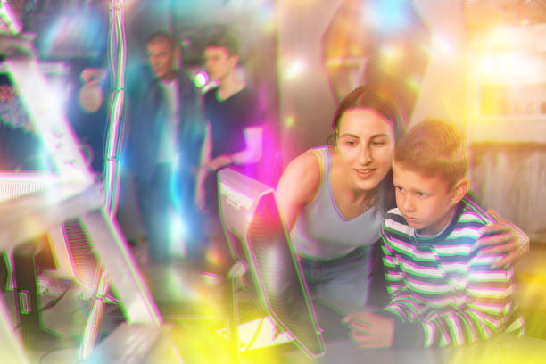 istock Young mother and preteen son using computer in quest room 1415816685