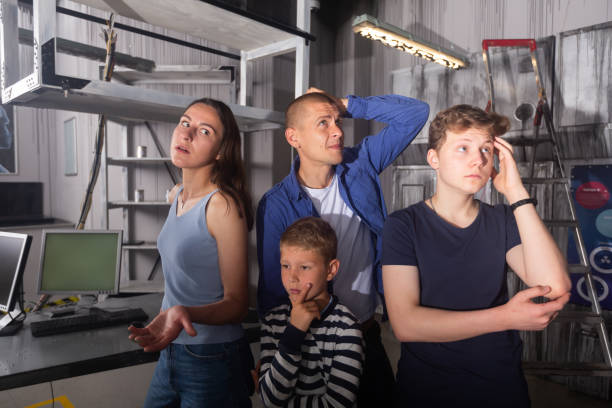 istock Brooding family tries to find a solution to a puzzle in a quest room 1415816686