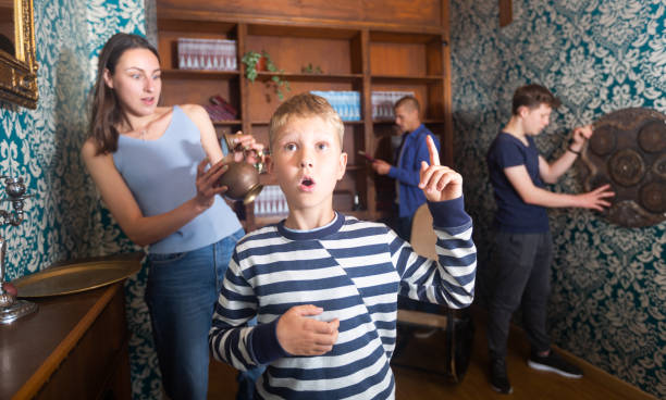 istock Smart preteen boy gesturing with forefinger in quest room 1415816711