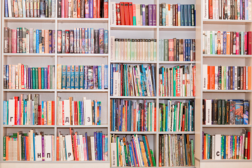 Library. Bookshelves. Bookcase with children's books.