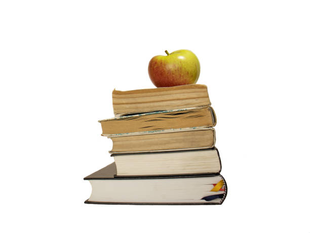 istock apple on a stack of books isolated on the white background 1415818646