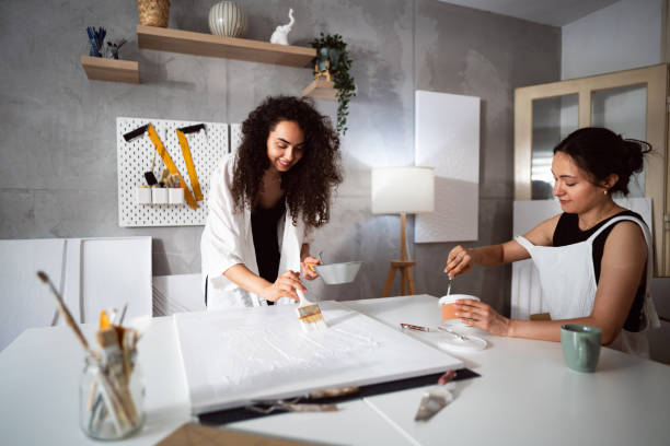 istock Two sisters making artworks in their studio 1415818781