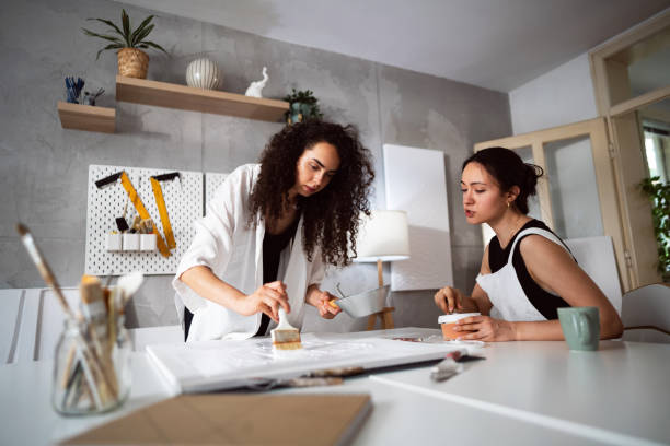 istock Two sisters making artworks in their studio 1415818783