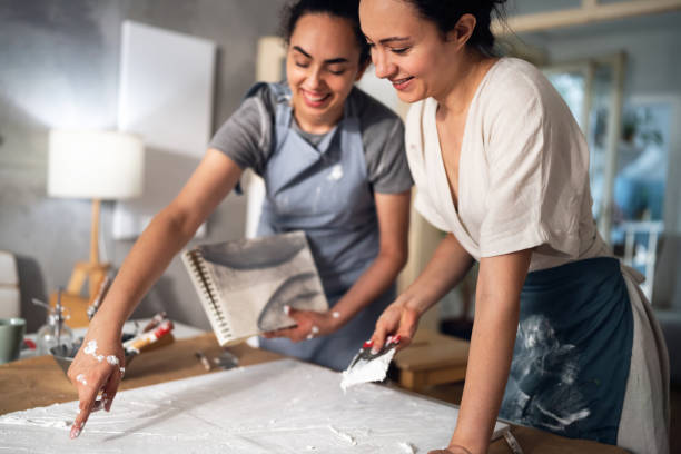 istock Two sisters making artworks in their studio 1415818820