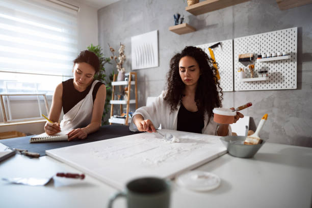 istock Two sisters making artworks in their studio 1415818824