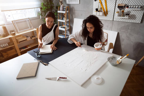 istock Two sisters making artworks in their studio 1415818866