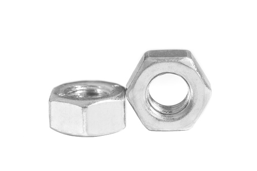 Close-up of two hexagonal steel nuts isolated on white background