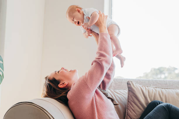istock Young mother and baby playing on couch 1415819022