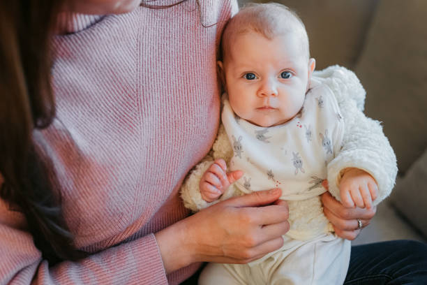 istock Baby in mother's arms looking at camera 1415819038