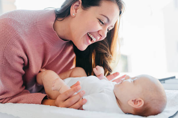 istock Cheerful young mother smiling at baby on changing table 1415819065