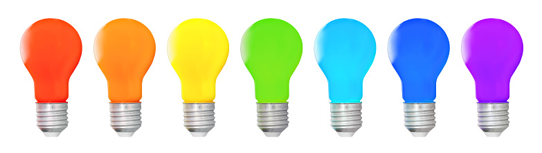 Row of rainbow colored incandescent light bulbs isolated on white background.