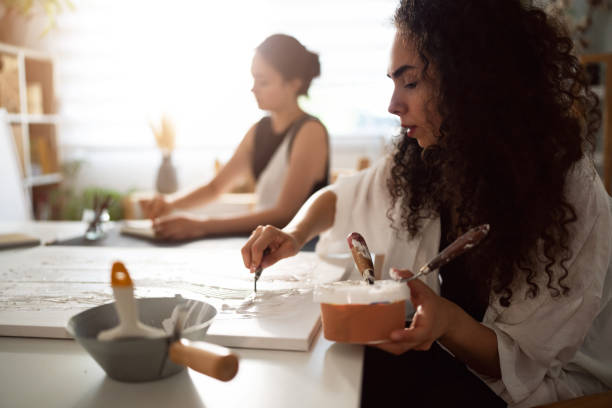 istock Two sisters making artworks in their studio 1415819187