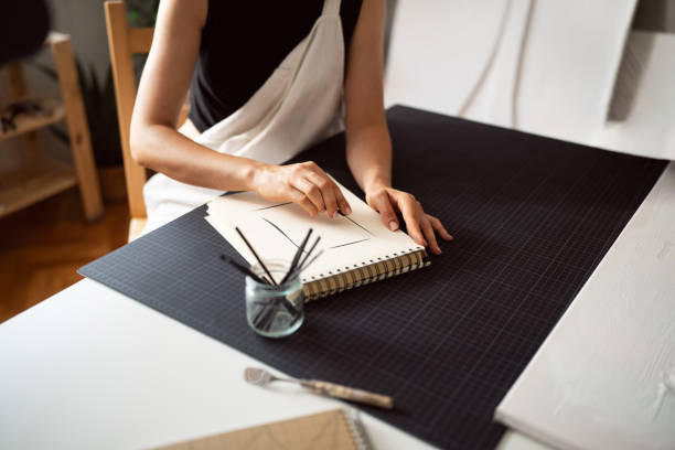 istock An anonymous woman drawing with charcoal in her studio 1415819308