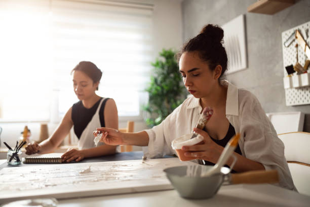 Two sisters making artworks in their studio