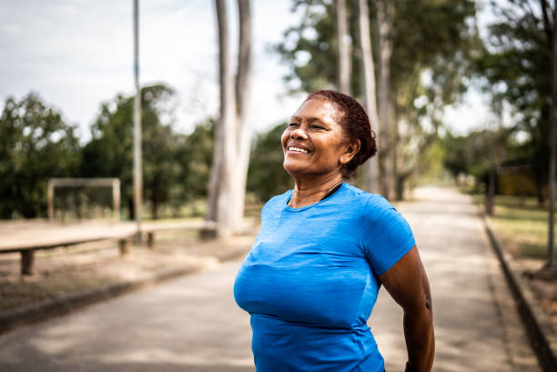 istock Senior woman stretching in a park 1415819481