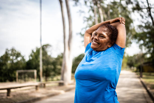 istock Senior woman stretching in a park 1415819498