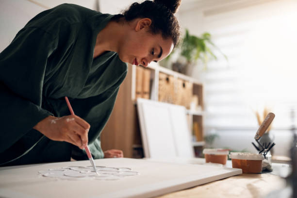 istock Young woman making art in her studio 1415820276