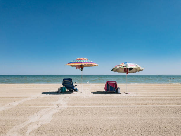 Parasol sub umbrella at the lonely beach and sea side. Holiday at an idyllic place at the Italian costline.
