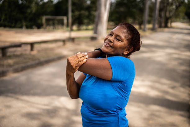 istock Senior woman stretching in a park 1415820892