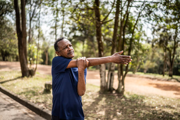 istock Senior man stretching in a park 1415820893