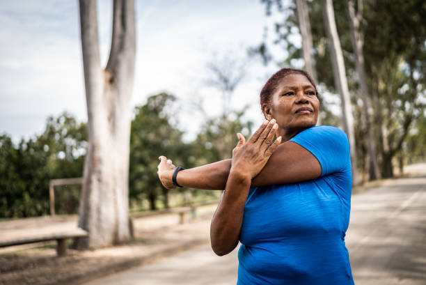 istock Senior woman stretching in a park 1415820894