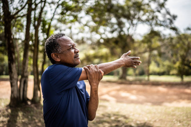 istock Senior man stretching in a park 1415820896