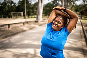Senior woman stretching in a park