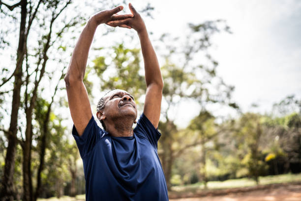istock Senior man stretching in a park 1415820907
