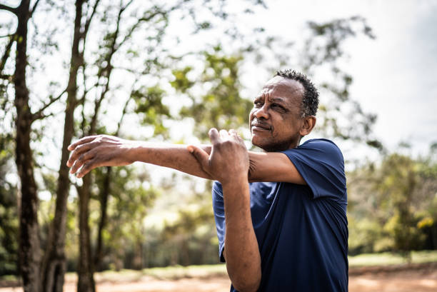 istock Senior man stretching in a park 1415820908