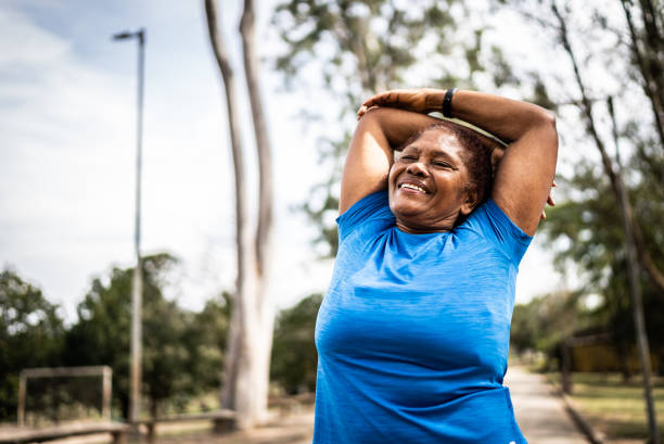 istock Senior woman stretching in a park 1415820916