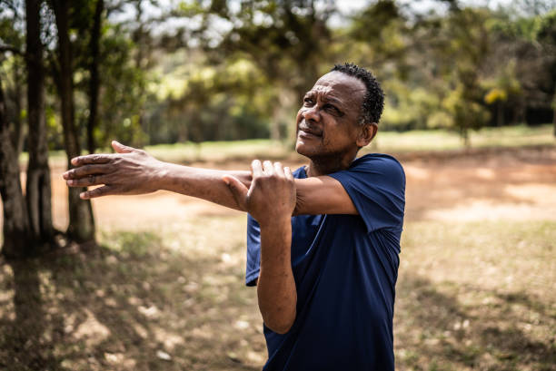istock Senior man stretching in a park 1415820923