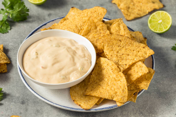 Homemade Creamy White Queso Dip Homemade Creamy White Queso Dip with Tortilla Chips cheese dip stock pictures, royalty-free photos & images