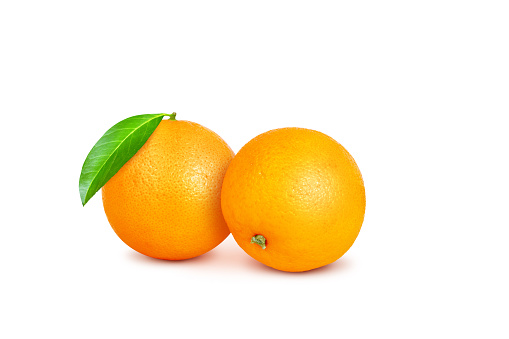 Full orange, two oranges, with green leaves isolated on a white background.