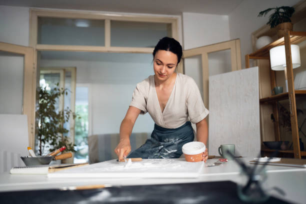 istock Young woman painting with acrylics in her studio 1415821681