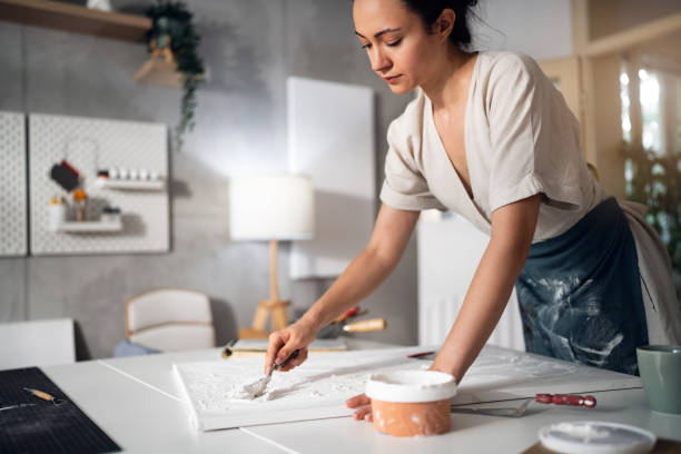 Young woman painting with acrylics in her studio