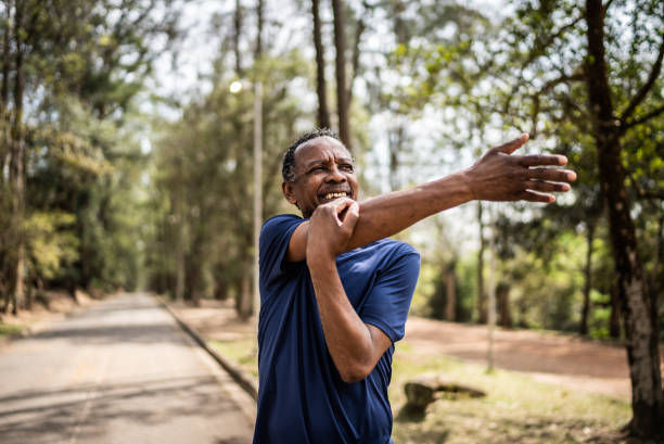 istock Senior man stretching in a park 1415822523