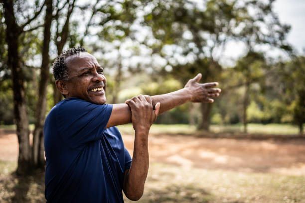 istock Senior man stretching in a park 1415822551