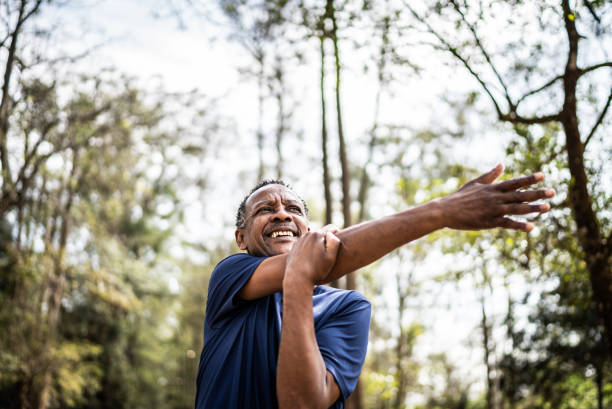 istock Senior man stretching in a park 1415822555