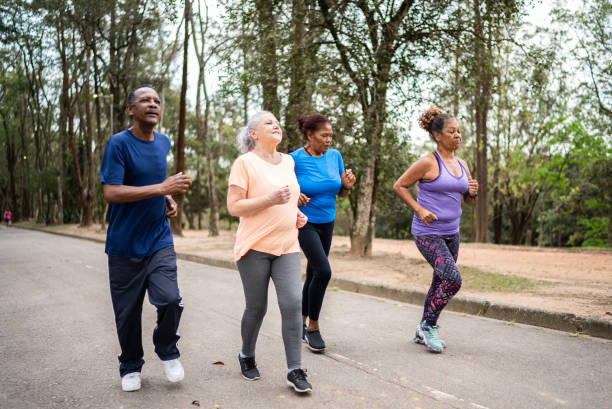 istock Senior friends walking in a park 1415824682