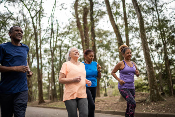 istock Senior friends walking in a park 1415824704
