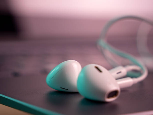 istock White headphones with a cable on a laptop. 1415827190