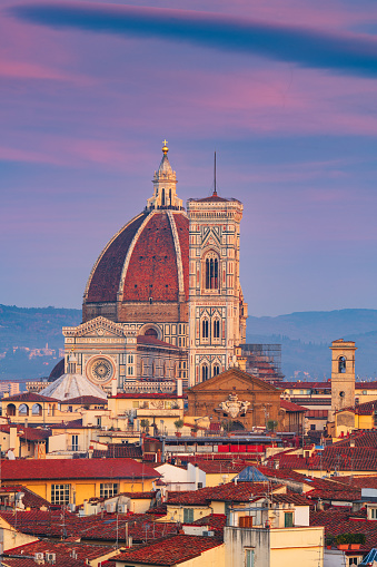 Florence, Italy skyline with landmark buildings at dusk over the Duomo.