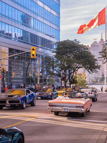 Windsor, Ontario, Canada - August 12, 2022:  Classic cars driving around downtown Windsor during  a classic car cruise community event.