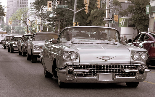 Windsor, Ontario, Canada - August 12, 2022:  Classic cars driving around downtown Windsor during  a classic car cruise community event.